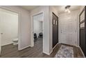 Bright foyer with luxury vinyl plank flooring and neutral colored walls with adjacent workout room at 261 Mesa Ave, Lochbuie, CO 80603