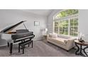 Bright living room features large windows, a comfortable chaise, and a grand piano, ideal for relaxation and entertainment at 10345 Lions Heart, Lone Tree, CO 80124