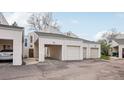 View of garages and carport with neutral siding and asphalt driveway at 1529 S Sable Blvd # C, Aurora, CO 80012