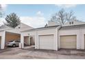 View of garages and carport with neutral siding and asphalt driveway at 1529 S Sable Blvd # C, Aurora, CO 80012