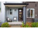 Inviting front porch features seating, modern accents, and brick and siding details at 9305 S Gore St # C, Arvada, CO 80007