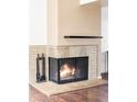 Close-up of the fireplace with tile surround and a decorative floating shelf at 3820 S Fraser St, Aurora, CO 80014