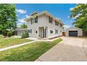 Inviting home with a spacious driveway and a detached garage, perfect for extra storage at 4142 Chase St, Denver, CO 80212