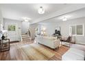 Bright and airy living room with hardwood floors, a modern staircase and stylish furnishings at 4142 Chase St, Denver, CO 80212