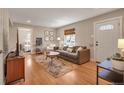 Inviting living room with hardwood floors, a gray couch, and an abundance of natural light at 5108 S Pennsylvania St, Littleton, CO 80121