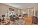 Comfortable living room featuring a couch, neutral colors, and hardwood flooring at 5108 S Pennsylvania St, Littleton, CO 80121