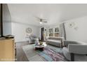The staged living room has modern decor and a ceiling fan at 811 Plum N Ave, Lochbuie, CO 80603
