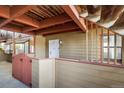Private patio with a white door and a white-and-red fence at 8770 Corona St # 101, Denver, CO 80229