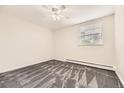 Carpeted bedroom featuring a ceiling fan, window and radiant heating at 2160 S Vaughn Way # 104C, Aurora, CO 80014