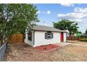 Exterior view of a charming home with tidy landscaping and a classic style at 1301 Kenton St, Aurora, CO 80010