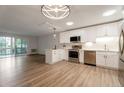 Open-concept kitchen boasts stainless steel appliances, white cabinets, and access to a private balcony at 625 S Alton Way # 3A, Denver, CO 80247