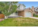 Well-maintained two-story home with charming porch and stone-accented garage, set on a green lawn at 5362 S Danube Ct, Centennial, CO 80015
