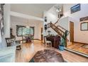 Open-concept living space with hardwood floors, high ceilings, and traditional decor at 5362 S Danube Ct, Centennial, CO 80015