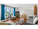 Bright living room featuring hardwood floors, comfortable furnishings, and an area rug at 3117 Victor St, Aurora, CO 80011