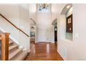 Inviting foyer with hardwood floors, soaring ceilings, and elegant staircase at 1519 Stonehill Ct, Castle Rock, CO 80104