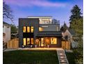 Modern home featuring a sleek brick exterior, multiple balconies, and a well-manicured lawn at 1544 S Fillmore St, Denver, CO 80210