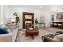 Cozy living room with an ornate fireplace, comfortable seating, and a view into the kitchen at 2849 N Vine St, Denver, CO 80205