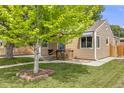 Attractive home with mature tree, landscaped yard, and cozy front porch at 430 Osceola St, Denver, CO 80204