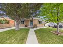 Inviting home with manicured lawn, mature trees, and pleasant curb appeal at 430 Osceola St, Denver, CO 80204