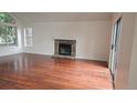 Spacious living room with hardwood floors and stone fireplace at 18531 E Tanforan Pl, Aurora, CO 80015