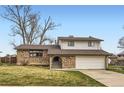 Charming two-story home with brick facade, well-maintained lawn, and attached two car garage under a blue sky at 789 Hamal Dr, Lone Tree, CO 80124