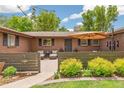Charming brick home featuring a cozy front patio with seating area at 12256 W 34Th Pl, Wheat Ridge, CO 80033