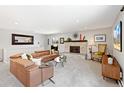 Cozy living room with a brick fireplace, neutral carpet, and ample space for comfortable seating at 12256 W 34Th Pl, Wheat Ridge, CO 80033