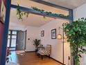 Bright entryway with natural light, wood floors, tasteful decor, and a decorative greenery accent at 3550 S Harlan St # 313, Denver, CO 80235