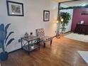 Cozy living room features wood floors, natural light, and decorative accents with greenery at 3550 S Harlan St # 313, Denver, CO 80235