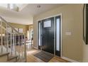 Warm and inviting foyer featuring wood floors, a modern front door, and adjacent living area at 1919 Breen Ln, Superior, CO 80027