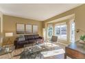 Sun-filled living room with hardwood floors, bay windows, and comfortable seating arrangement at 1919 Breen Ln, Superior, CO 80027