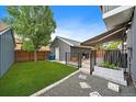 Secluded backyard featuring a shed, a patio with awning, and landscaped elements at 8699 Garrison Ct, Arvada, CO 80005