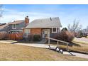Charming single-story home with brick and gray siding, complemented by a well-maintained front yard at 8699 Garrison Ct, Arvada, CO 80005