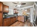 Modern kitchen featuring dark wood cabinets and granite countertops at 11012 Blackwolf Ln, Parker, CO 80138