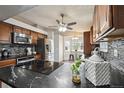 Spacious kitchen boasts granite countertops and stainless steel appliances at 11012 Blackwolf Ln, Parker, CO 80138