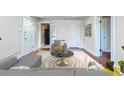 Bright living room featuring hardwood floors, a neutral color palette, and modern furnishings at 700 E Ellsworth Ave # 2, Denver, CO 80209