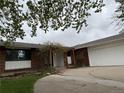 Image of front entrance to brick home with pergola and mature landscaping at 8895 E Radcliff E Ave, Denver, CO 80237