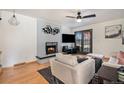 Cozy living room featuring a fireplace with decorative mantle and backyard access at 8895 E Radcliff E Ave, Denver, CO 80237