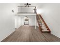 Open-concept living room with vaulted ceilings, ceiling fan, and staircase to the loft at 326 Wright St # 304, Lakewood, CO 80228