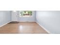 Bright living room featuring hardwood floors and a large window for natural light at 5099 S Linden Dr, Englewood, CO 80110