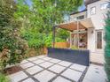 Cozy backyard patio with pavers, landscaping, pergola, and string lights perfect for outdoor entertaining at 4535 Stuart St, Denver, CO 80212