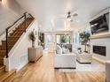 Bright and airy living room showcasing hardwood floors, fireplace, and open layout to the kitchen and dining area at 4535 Stuart St, Denver, CO 80212