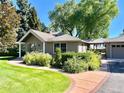 Charming home exterior with lush garden and a brick pathway at 4600 S University Blvd, Englewood, CO 80113