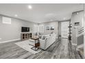 Bright living room with stylish decor, hardwood floors, and large windows at 9694 Dunning Cir, Highlands Ranch, CO 80126