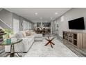 Open concept living area flowing into the dining room with modern finishes at 9694 Dunning Cir, Highlands Ranch, CO 80126