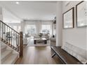 Elegant living room featuring hardwood floors, plush seating, and abundant natural light streaming through large windows at 4781 Saddle Iron Rd, Castle Rock, CO 80104