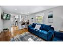Bright living room featuring a comfortable blue sofa, hardwood floors, and modern decor at 5570 Otis Ct, Arvada, CO 80002