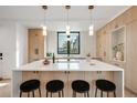 Contemporary kitchen featuring a large island, pendant lighting, and modern cabinetry at 1459 W 42Nd Ave, Denver, CO 80211