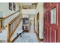 Bright entryway with hardwood floors, open staircase, and a glimpse of the upper level at 4498 Buena Vista Ct, Castle Rock, CO 80109