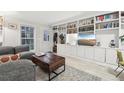 Bright living room with custom built-in bookshelves and a large window at 1198 Milo Cir # A, Lafayette, CO 80026